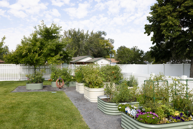 6936 South 775 East, Unit B Midvale, UT 84047 - Photo 27 of 33 Fenced backyard with a vegetable garden and a patio area