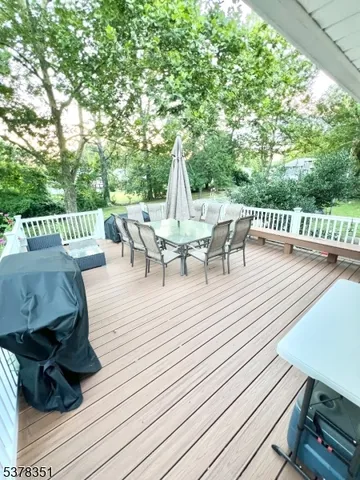 a view of a patio with table and chairs and wooden floor