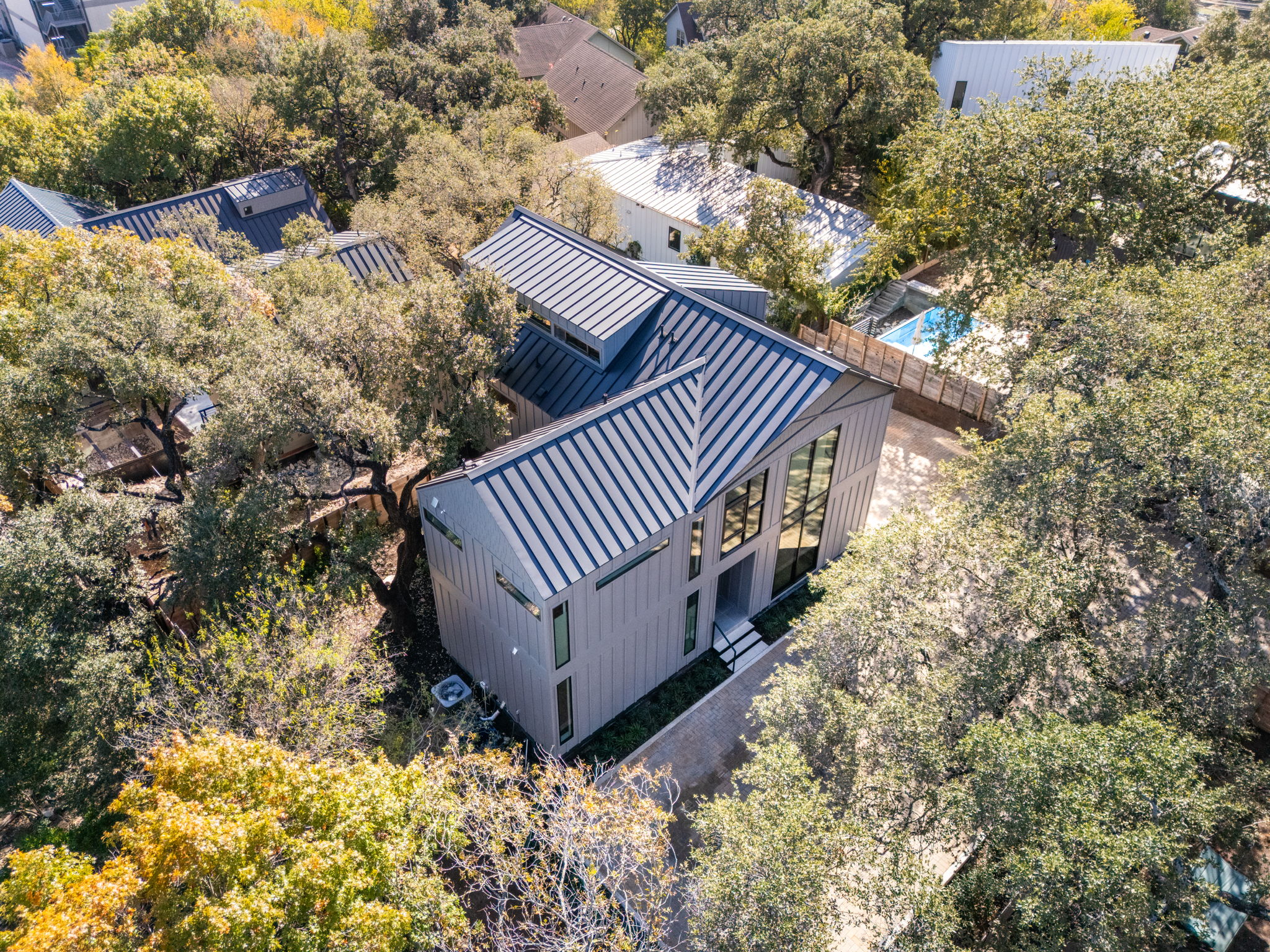 1603 Chelsea Lane, Unit 1 Austin, TX 78704 - Photo 34 of 34 Bold metal roofing and vertical siding define this modern architectural design nestled among mature trees.