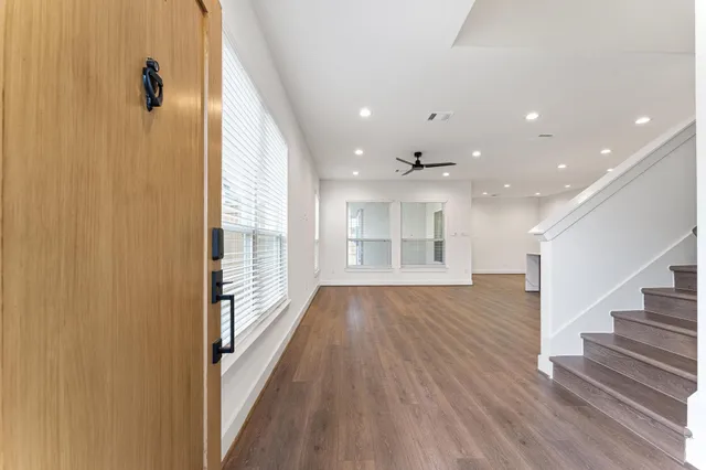 wooden floor in an empty room with wooden floor and a window