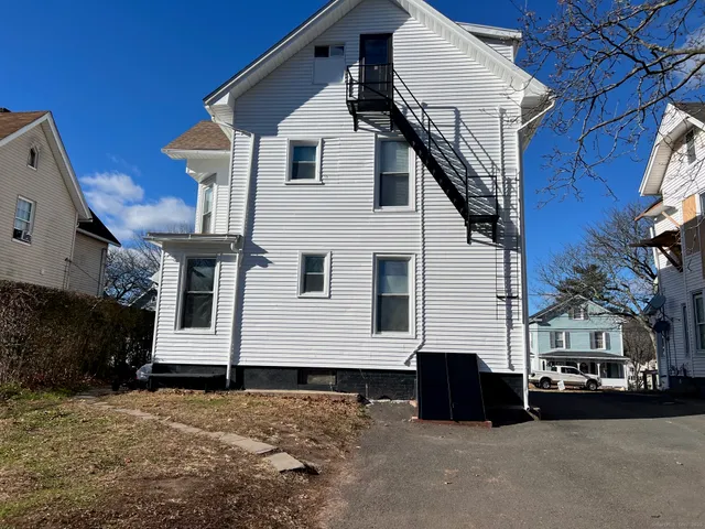 a view of a white house with a street