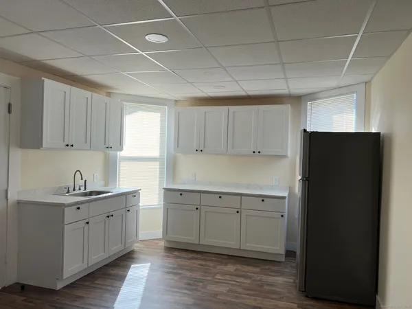 a kitchen with a sink stainless steel appliances and cabinets