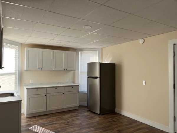 a kitchen with a refrigerator and cabinets