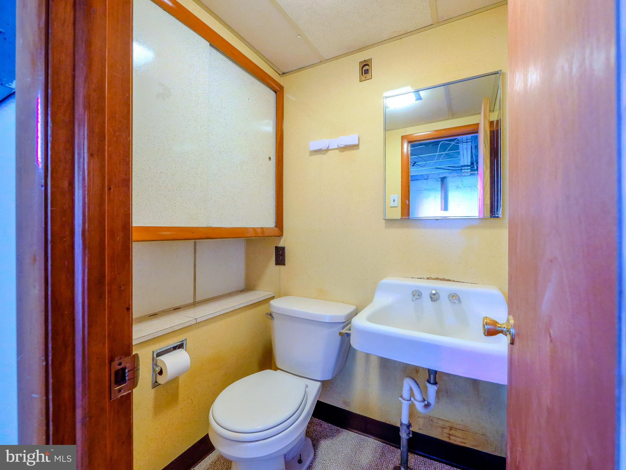 7154 Ruskin Lane Upper Darby, PA 19082 - Photo 22 of 28 a white toilet sitting next to a bathroom sink