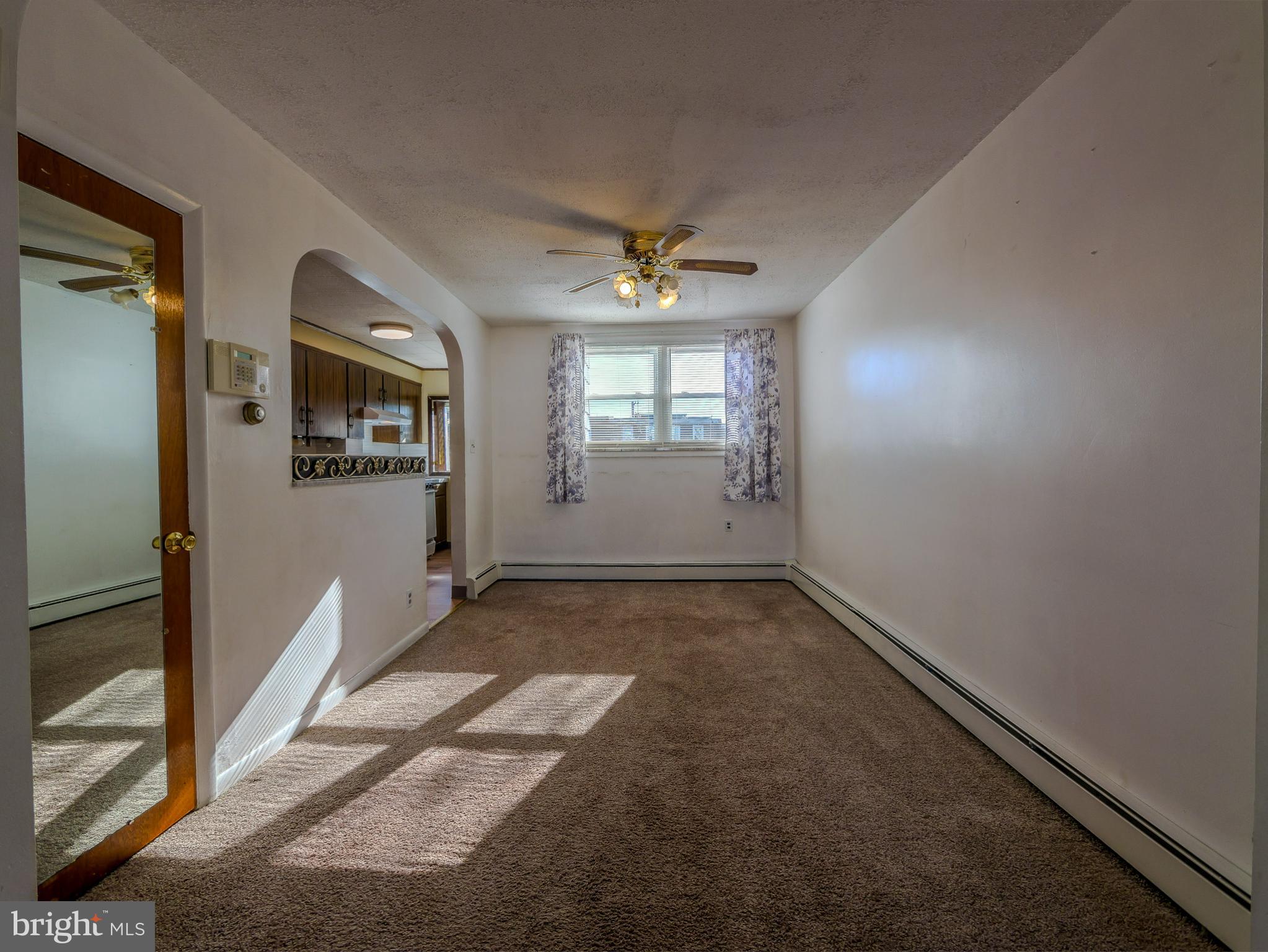 7154 Ruskin Lane Upper Darby, PA 19082 - Photo 4 of 28 an empty room with windows and ceiling fan