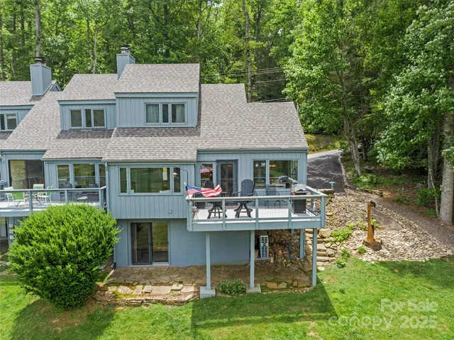 a view of a house with a yard and sitting area