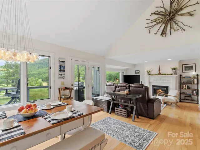 a living room with furniture fireplace and a large window