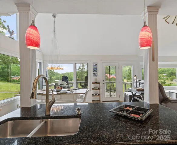 a living room with furniture and a floor to ceiling window