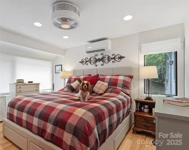 a bedroom with a bed and a chandelier