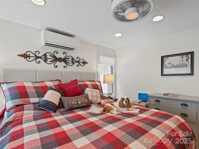 a bedroom with a bed and a chandelier