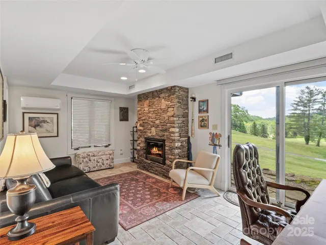 a living room with furniture a fireplace and a flat screen tv