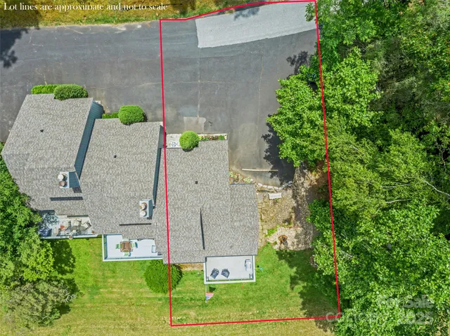 an aerial view of a house with a garden and a car parked