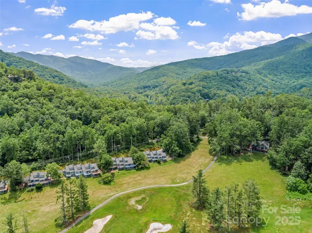 a view of a lake with houses in the back