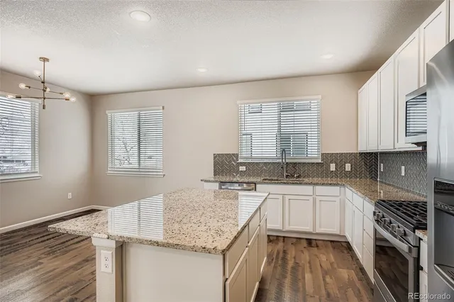 a kitchen with a sink stove and cabinets