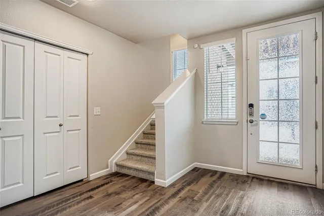 a view of kitchen with stainless steel appliances kitchen island wooden floor and window