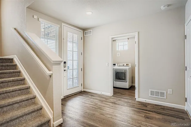 a view of an entryway with wooden floor and stairs
