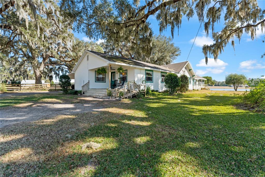 9504 Fort King Road Dade City, FL 33525 - Photo 8 of 14 a front view of a house with a garden