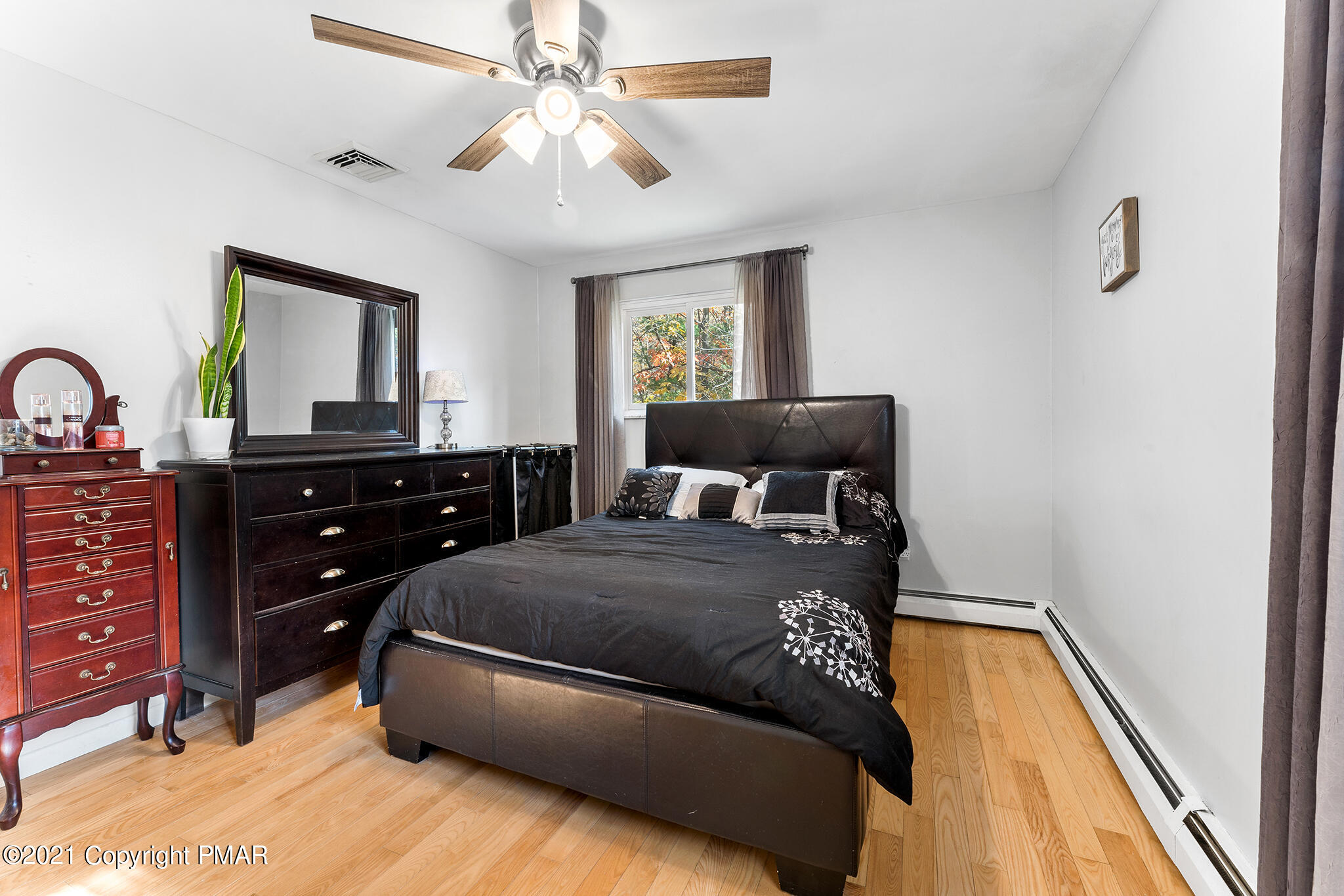 177 Tyrolean Way Henryville, PA 18332 - Photo 16 of 27 a bedroom with a bed and a chandelier