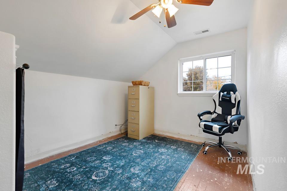 1230 East Main Street Weiser, ID 83672 - Photo 13 of 25 Unfurnished room with lofted ceiling, ceiling fan, and wood-type flooring