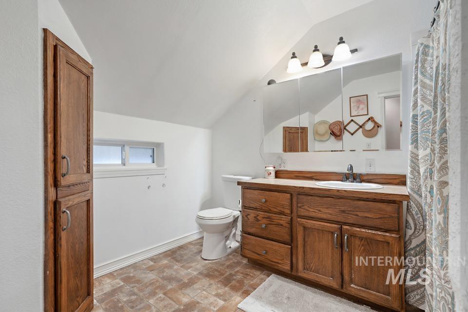 1230 East Main Street Weiser, ID 83672 - Photo 18 of 25 Bathroom featuring vanity and lofted ceiling