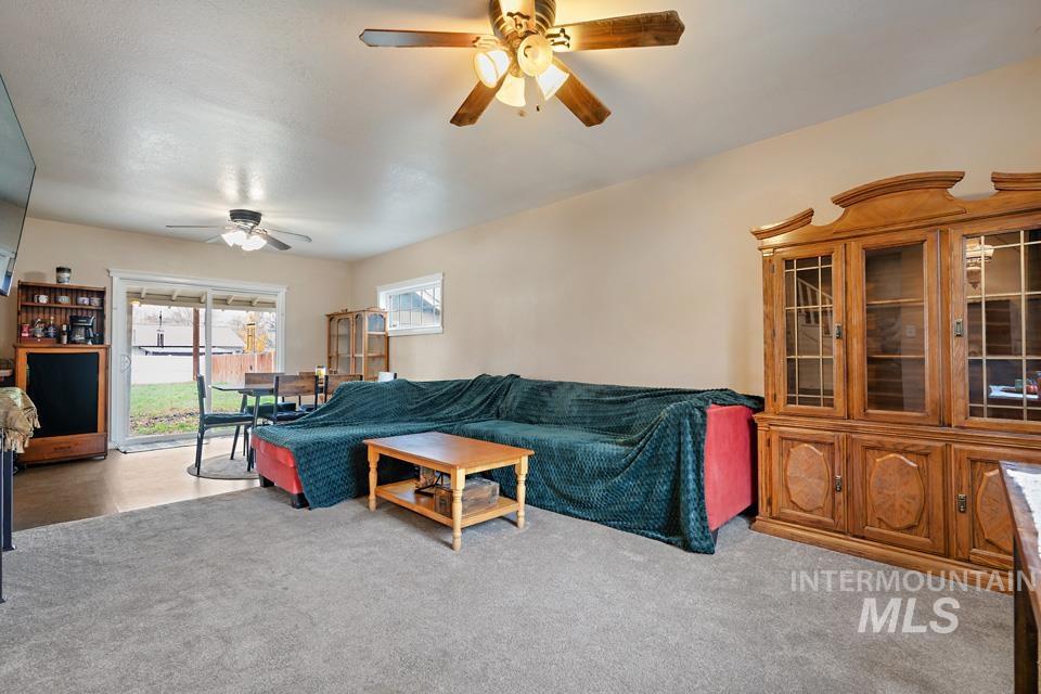1230 East Main Street Weiser, ID 83672 - Photo 2 of 25 Living area with light colored carpet and a ceiling fan