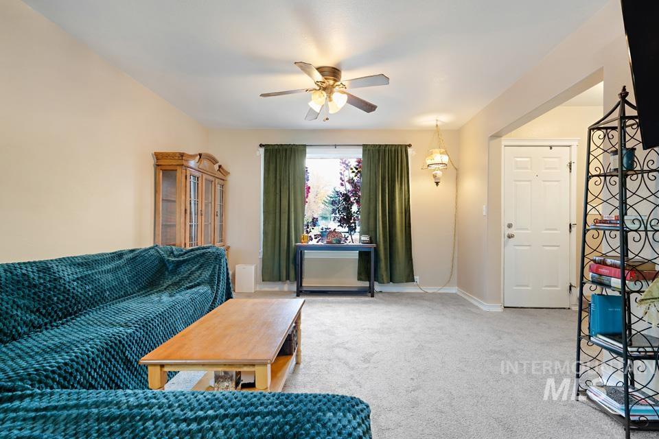 1230 East Main Street Weiser, ID 83672 - Photo 3 of 25 Carpeted living area featuring a ceiling fan and baseboards