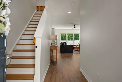 a view of entryway and hall with wooden floor
