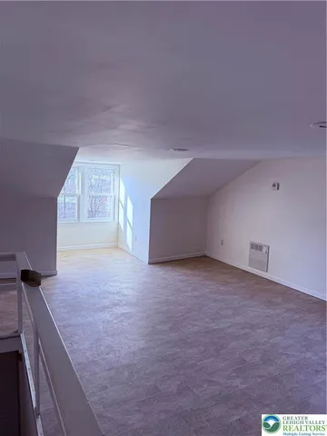 a view of an empty room with a fireplace