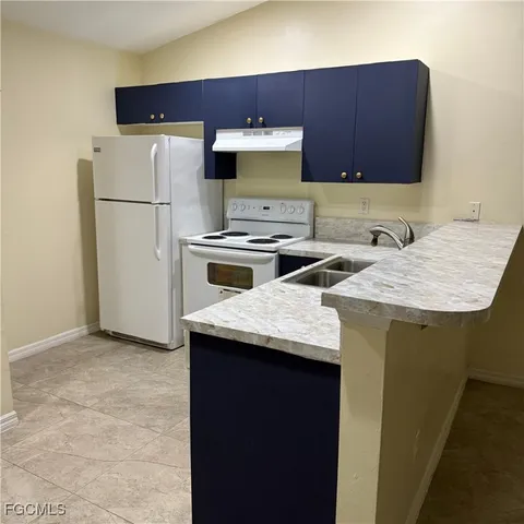 a kitchen with refrigerator and stove