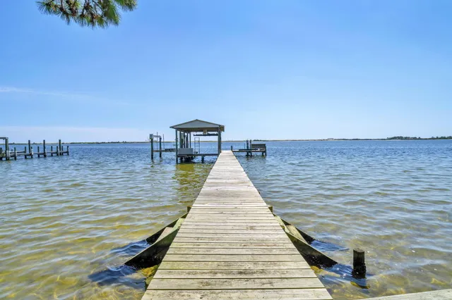 a view of a hallway with a couch and wooden floor