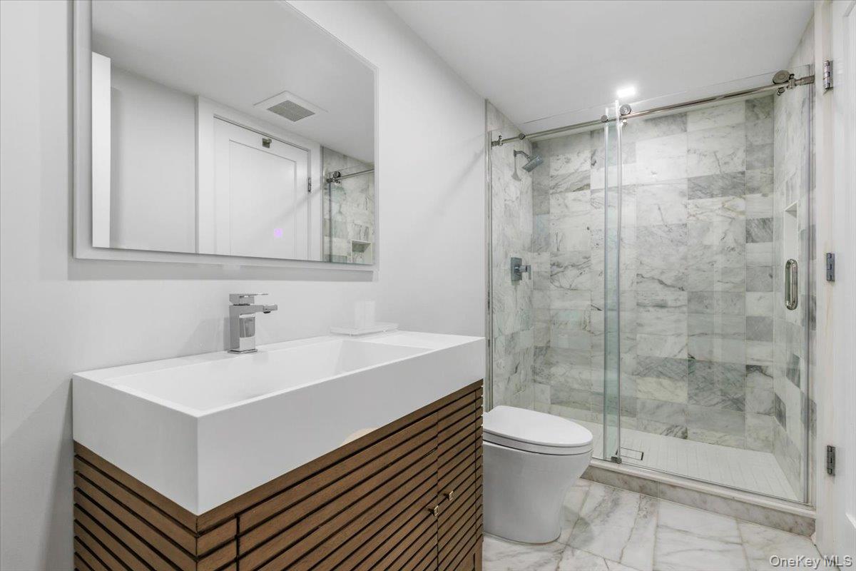 100 Dearborn Avenue Rye, NY 10580 - Photo 35 of 49 Lower level bathroom with convenient access to bedroom as well as main recreational space.