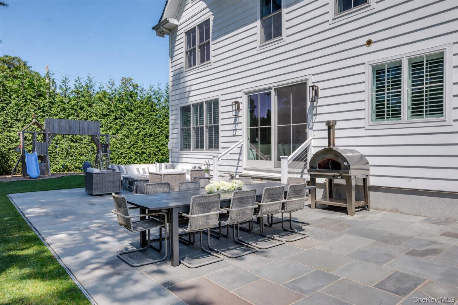 100 Dearborn Avenue Rye, NY 10580 - Photo 38 of 49 The patio is surrounded by mature privacy trees and ample flat, lush property.