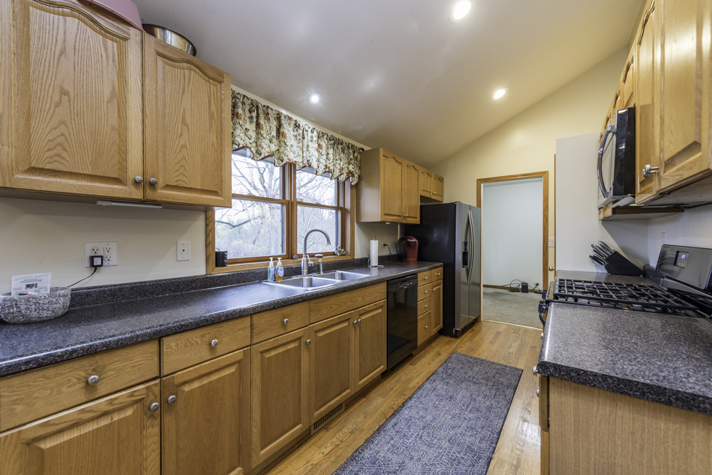 35861 North Fuller Road Gurnee, IL 60031 - Photo 12 of 30 a kitchen with stainless steel appliances granite countertop a sink stove and refrigerator