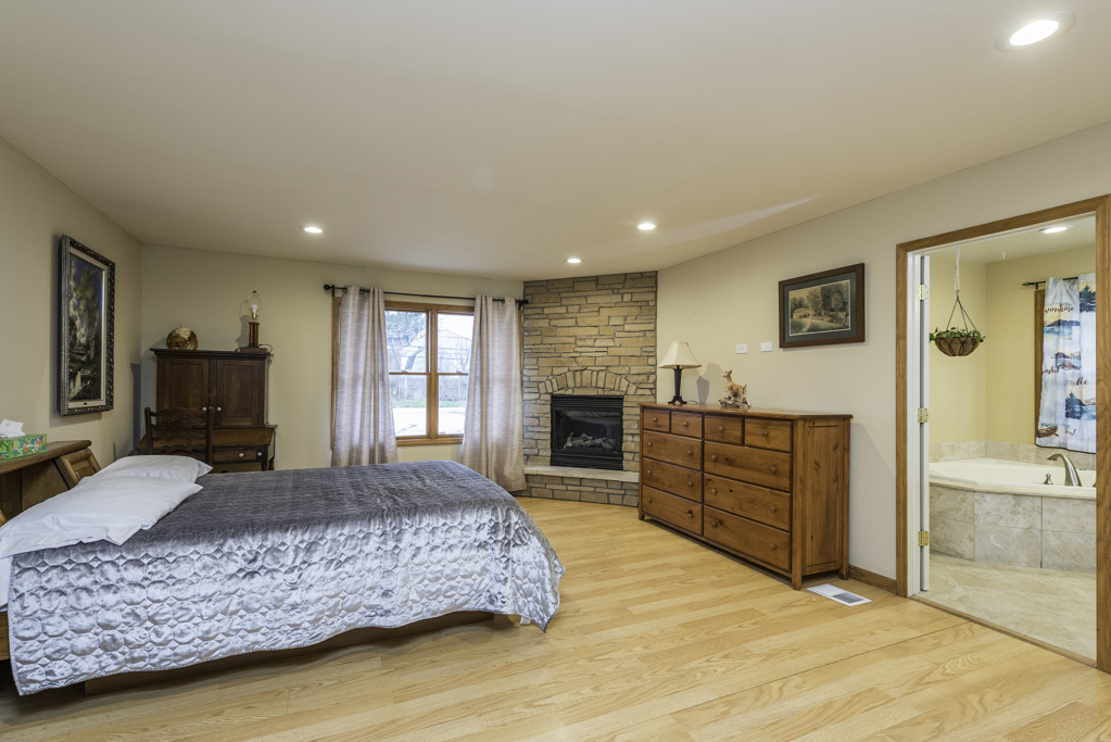 35861 North Fuller Road Gurnee, IL 60031 - Photo 14 of 30 a large bedroom with a large bed and a flat screen tv