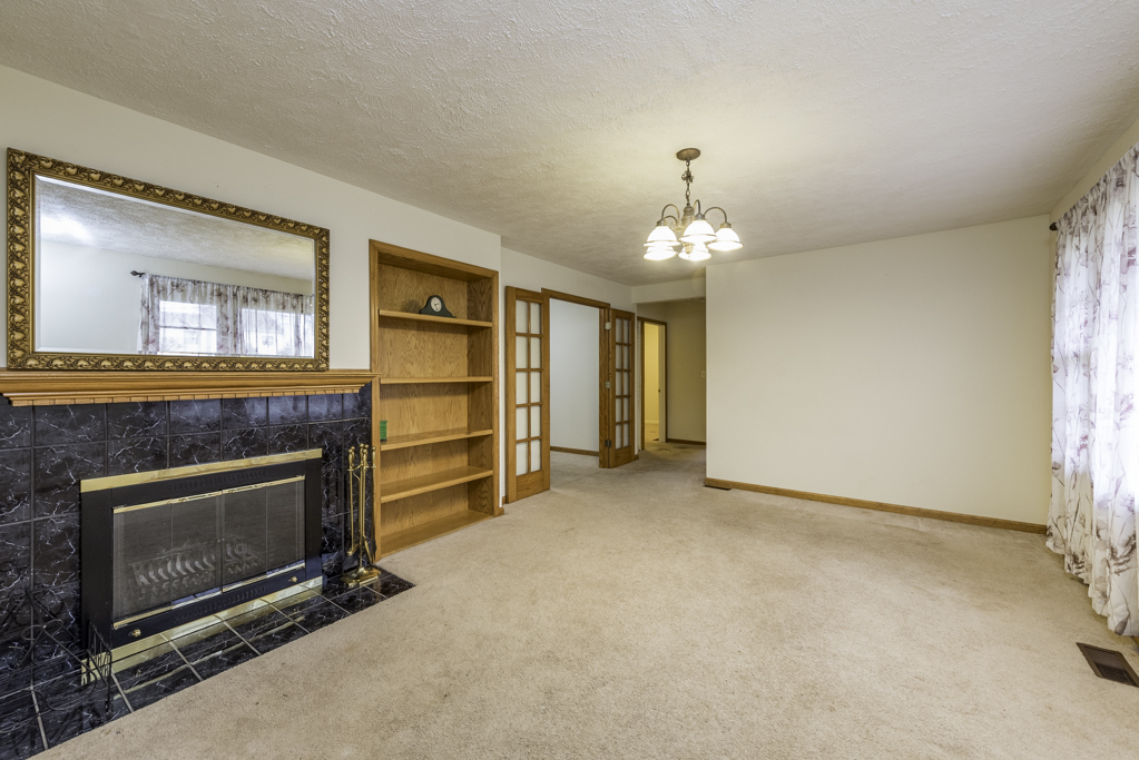 35861 North Fuller Road Gurnee, IL 60031 - Photo 6 of 30 a view of an empty room with a fireplace and a window