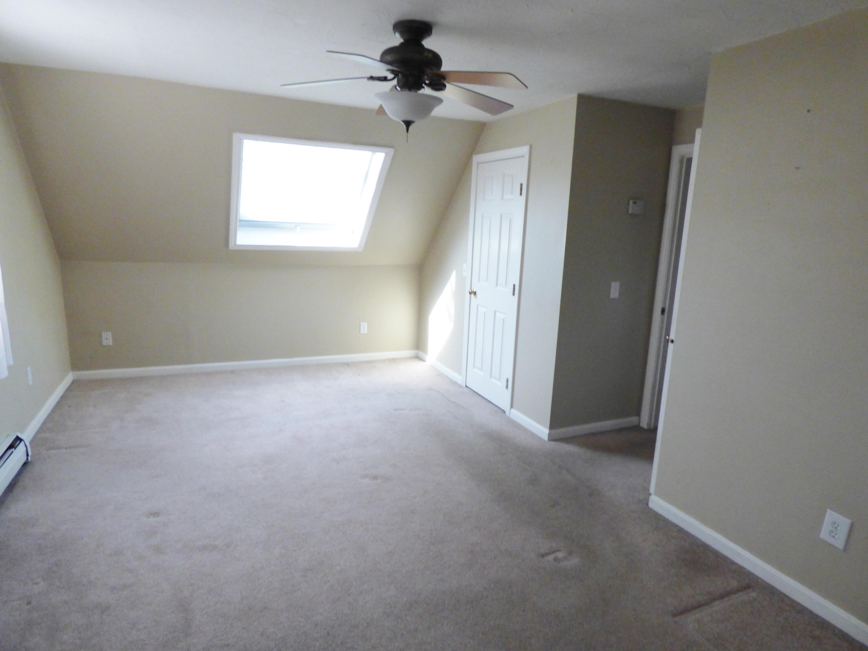 33 Lakeview Drive Sandwich, MA 02563 - Photo 16 of 32 en empty room with windows and a ceiling fan