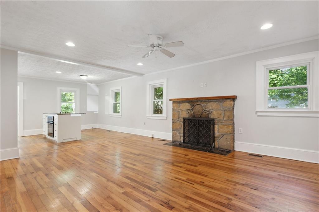 385 Sunset Drive Athens, GA 30606 - Photo 11 of 48 an empty room with wooden floor fireplace and windows