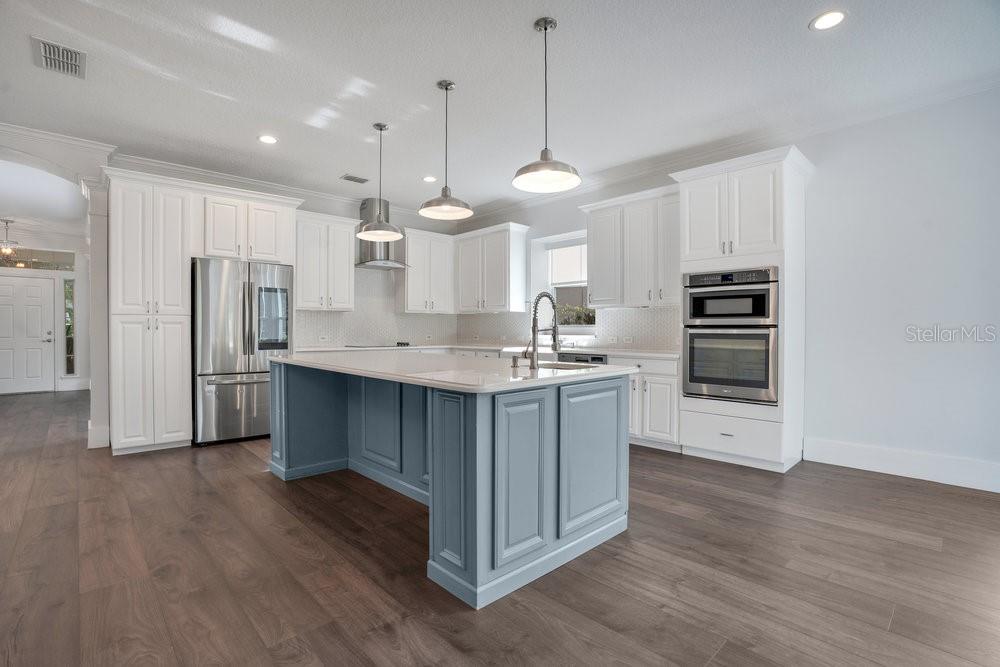 8399 Bowden Way Windermere, FL 34786 - Photo 11 of 59 a kitchen with stainless steel appliances kitchen island a refrigerator and a stove top oven
