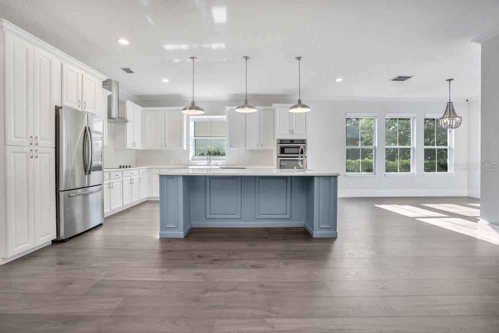 8399 Bowden Way Windermere, FL 34786 - Photo 12 of 59 a kitchen with stainless steel appliances granite countertop a stove a refrigerator and a sink