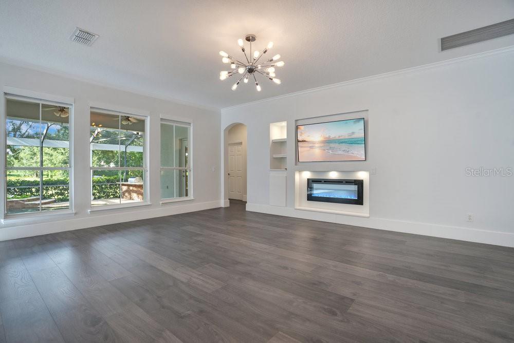 8399 Bowden Way Windermere, FL 34786 - Photo 15 of 59 a view of an empty room with wooden floor and a window