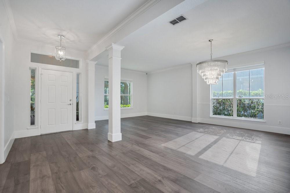 8399 Bowden Way Windermere, FL 34786 - Photo 19 of 59 a view of an empty room with wooden floor and a window