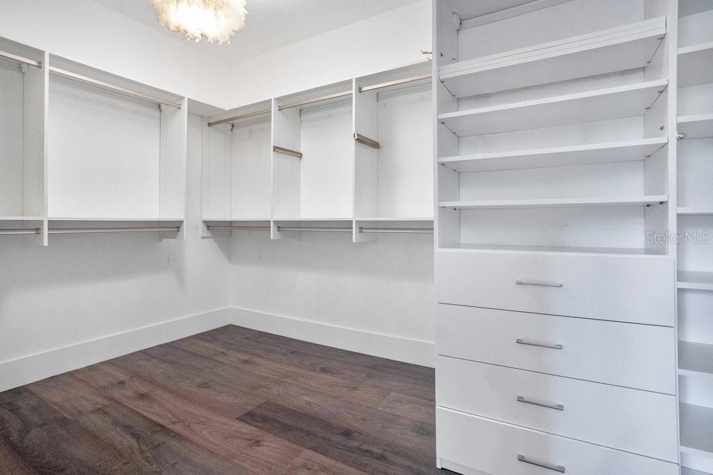 8399 Bowden Way Windermere, FL 34786 - Photo 25 of 59 a view of walk in closet with empty racks