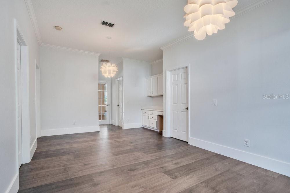 8399 Bowden Way Windermere, FL 34786 - Photo 26 of 59 a view of an empty room with wooden floor and a window