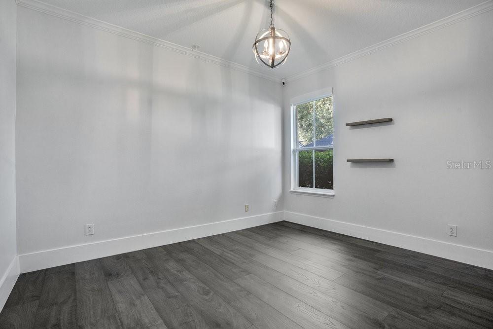 8399 Bowden Way Windermere, FL 34786 - Photo 29 of 59 an empty room with wooden floor and windows