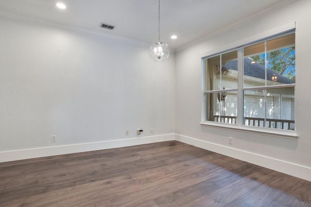 8399 Bowden Way Windermere, FL 34786 - Photo 31 of 59 a view of an empty room with wooden floor and a window