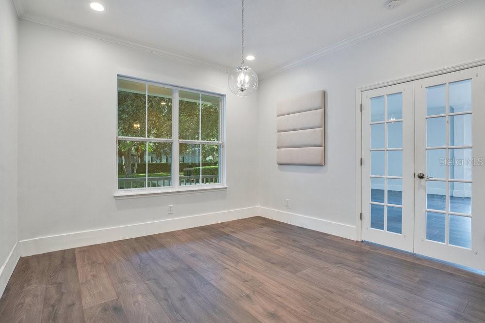 8399 Bowden Way Windermere, FL 34786 - Photo 33 of 59 a view of an empty room with wooden floor and windows