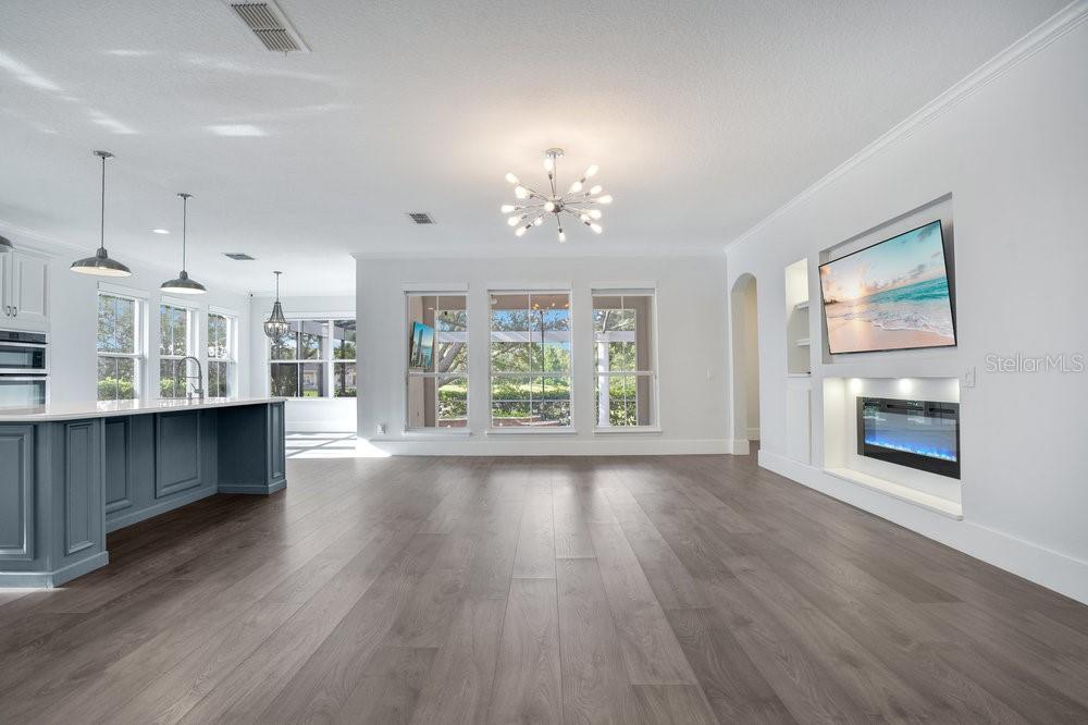 8399 Bowden Way Windermere, FL 34786 - Photo 4 of 59 a view of a living room with wooden floor and a kitchen