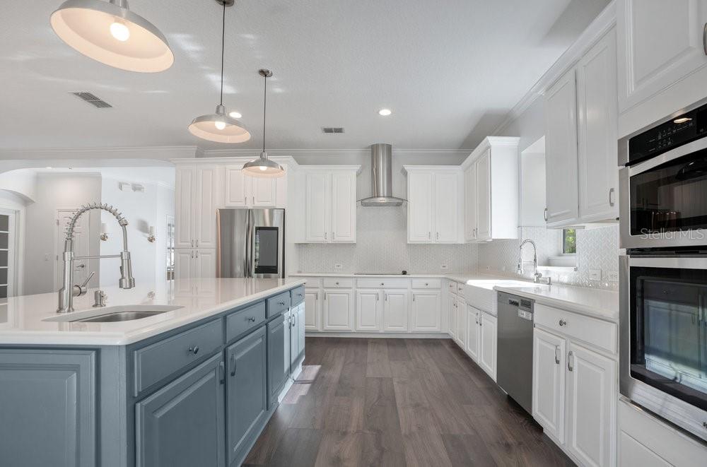 8399 Bowden Way Windermere, FL 34786 - Photo 8 of 59 a large kitchen with a sink and cabinets