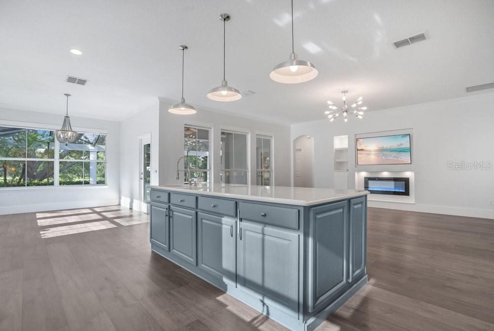 8399 Bowden Way Windermere, FL 34786 - Photo 10 of 59 a large kitchen with kitchen island white cabinets and chandelier