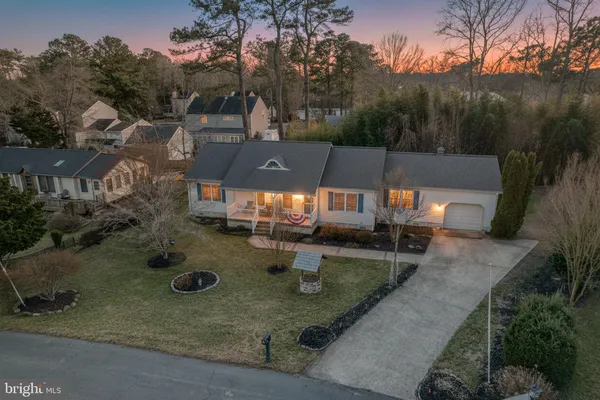 an aerial view of a house with backyard